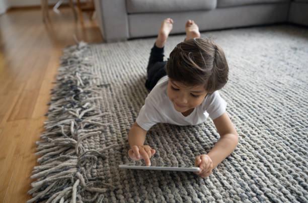 Girl lying on rug flooring | Broadway Carpets, Inc