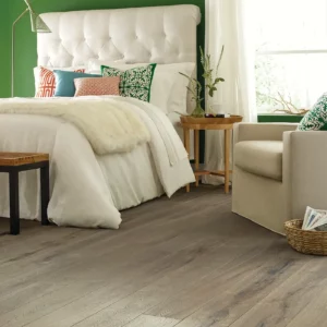 2W745_07028_ROOM Gray-toned hardwood in a bedroom with a white tufted headboard | Broadway Carpet & Flooring