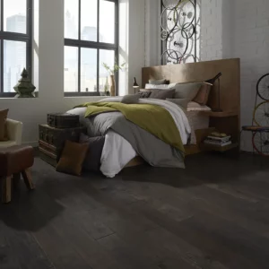 YukonMapleII-SW548-05002-Timberwolf-BedRm Dark hardwood in a modern bedroom with a large bed | Broadway Carpet & Flooring