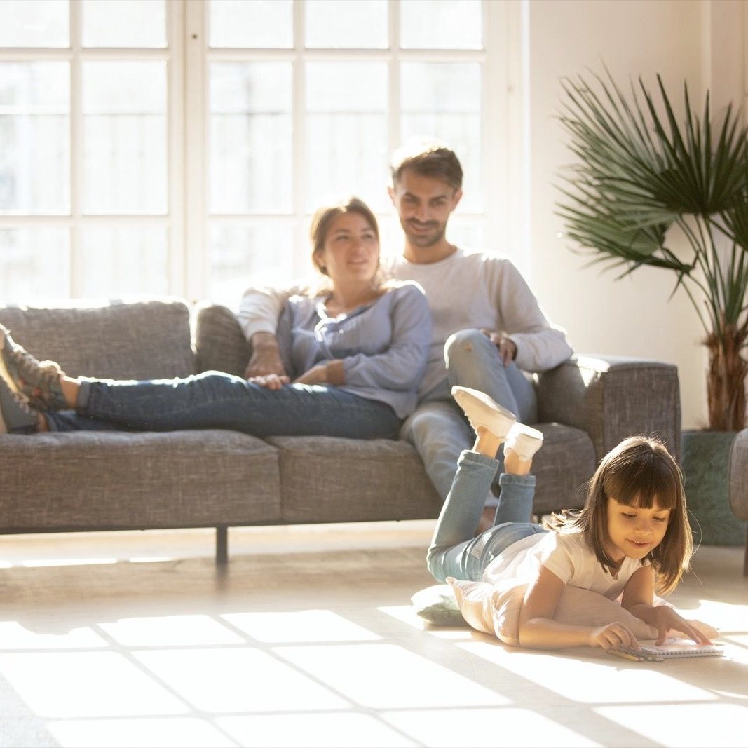 Family enjyng in living room | Broadway Carpets, Inc