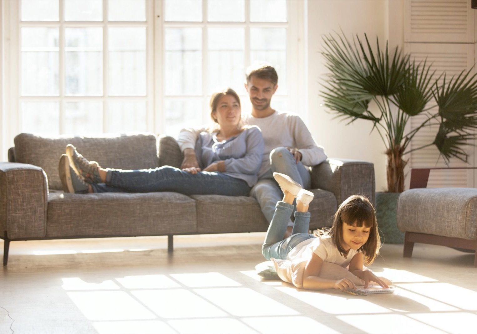 Family enjyng in living room | Broadway Carpets, Inc